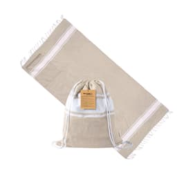 A beige drawstring bag with a white stripe design, displayed alongside a matching towel. The bag features a logo.