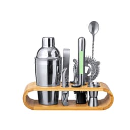 A stainless steel cocktail shaker set with a bamboo stand, including various tools like a strainer, jigger, and stirrer.