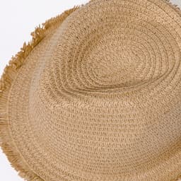 A light brown straw hat with a textured weave and frayed edges. Features a logo on the band.