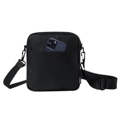 A black shoulder bag with a front pocket containing a smartphone. The bag features an adjustable strap and a logo.