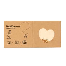 A cardboard seed packet with planting instructions, featuring heart-shaped cutout and flower seeds inside.
