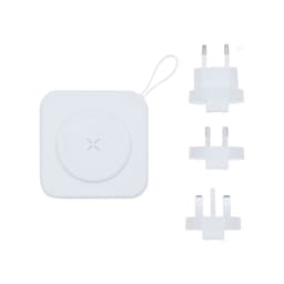 A white travel adapter with interchangeable plug types, featuring a circular charging pad on top.