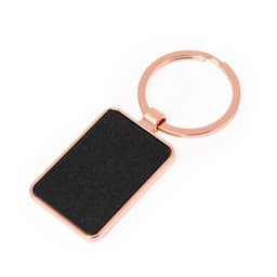 A rose gold keyring with a rectangular black panel, featuring a smooth texture and a metal attachment.