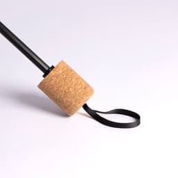 A drink bottle with a cork and black strap is featured in the image. The design includes a sleek black body.