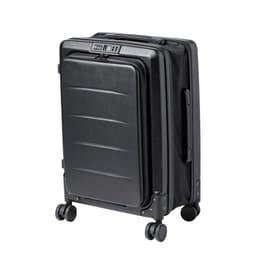A black wheeled bag featuring a hard shell design and four spinner wheels, with a built-in combination lock.