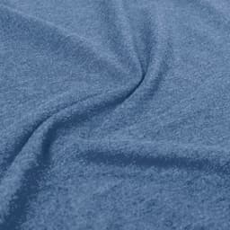 A close-up of a blue fabric, featuring a soft texture and a slight stretch. The image highlights the material's weave.