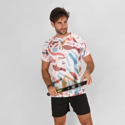 A casual t-shirt featuring a multicoloured abstract pattern, worn by a man holding a tennis racquet.