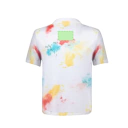 A kids' T-shirt featuring a white base with colourful splashes of blue, yellow, and red, and a branding logo on the back.