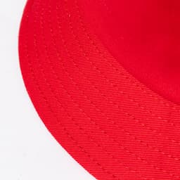A red brim hat featuring a wide brim and visible stitching details. Includes a logo on the band.