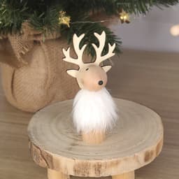 A decorative wooden reindeer with antlers and a white fluffy beard, positioned on a round wood slice.