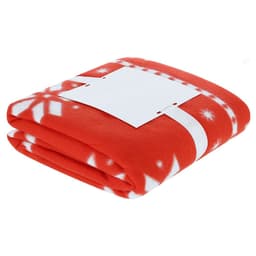 A folded red blanket featuring a white snowflake pattern, secured with a plain white band.