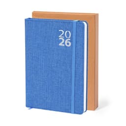A blue diary with the year 2026 on the cover, resting against a brown diary. Both have a logo on them.