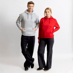 A grey hoodie and a red hoodie are worn by a man and a woman, both paired with dark trousers. Each hoodie has a logo.