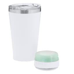 An insulated white travel mug with a clear lid, accompanied by a small green and white speaker.