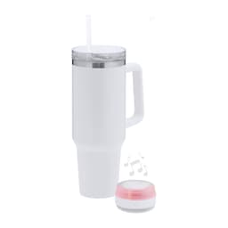 A drink bottle in white with a removable lid and straw, accompanied by a small, round Bluetooth speaker with a pink trim.