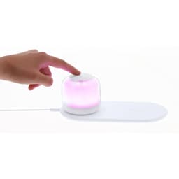 A wireless charger featuring a white base and a translucent pink-lit dome. It has a touch control button on top.