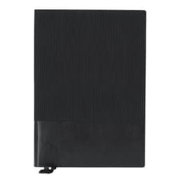 A black notebook with a textured cover and a smooth section at the bottom, featuring a closing strap.