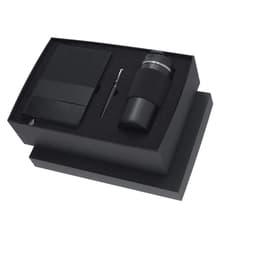 A drink bottle, notepad, and pen in a black gift box, featuring a logo. The items are arranged on a black background.