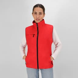 A red sleeveless jacket with a high collar, zip closure, and pockets, worn by a model.