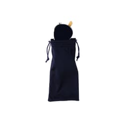 A navy drawstring bag containing a round, reflective object with a wooden handle, likely sunglasses or an accessory.