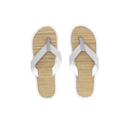 A pair of white thongs with a silver strap and a textured natural colour sole. Features a logo on the strap.