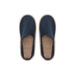 Navy blue slip-on slippers with a beige woven trim and a textured jute insole. Features branding on the side.
