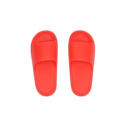 A pair of bright red thongs with a simple design and a smooth finish, featuring a logo on the side.