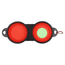 A foldable pet bowl in red and green, featuring a black exterior and a clip for easy attachment.