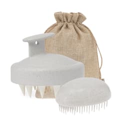 A grey hair scalp massager and brush, accompanied by a natural textured drawstring bag.