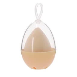A beige beauty application sponge inside a clear egg-shaped case, featuring a hanging loop on top.