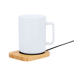 A white ceramic mug on a wooden coaster with a black electrical cord, designed for heating beverages.