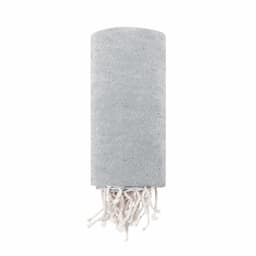 A rolled grey towel with a textured finish and white fringed edges. It features a subtle branding logo.