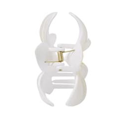 A white clip with a spring mechanism, designed for holding items together. Features a simple, functional design.