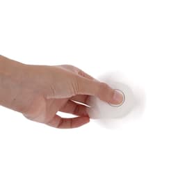 A fidget spinner is held in a hand, featuring a simple white design with a circular centre.