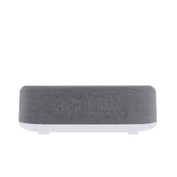 A wireless charger in grey fabric and white plastic, featuring a sleek, modern design. It has a logo on the front.