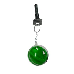 A green spherical keychain with a clear casing, attached to a metal keyring and a key.