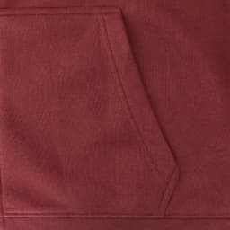 A maroon hoodie featuring a front pocket and a textured fabric. The design includes a logo.