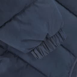 A navy puffer jacket featuring a gathered cuff detail and quilted texture. The jacket has a logo present.