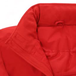 A close-up of a red puffer jacket's inner collar with a soft fabric lining and an attached tag.