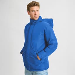 A blue puffer jacket with a hood, featuring a front zip and side pockets, is worn by a man.