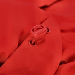 A close-up of a red puffer jacket featuring a toggle and eyelet detail, with a smooth textured fabric.