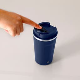A drink bottle in navy blue features a lid with a digital display and a hand pressing the top. It has a logo.