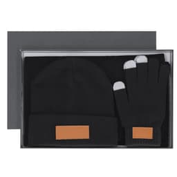 A black gift set featuring a beanie and gloves, both with a tan leather label, presented in a stylish box.