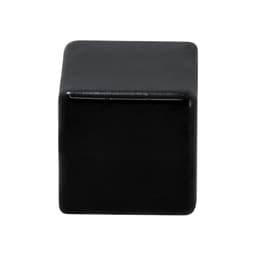 A black stress relief cube with a smooth surface, featuring rounded edges and no visible branding.
