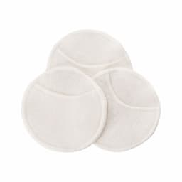 Three circular, fluffy, cream-coloured reusable breast pads arranged together, featuring a textured edge and a smooth surface.