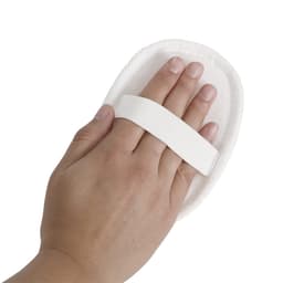 A hand is holding a white, soft mitt with an elastic strap, designed for personal care.