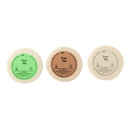 Three circular soap packages in green, brown, and beige, each labelled with "Soap" and weight. Each has a simple design.
