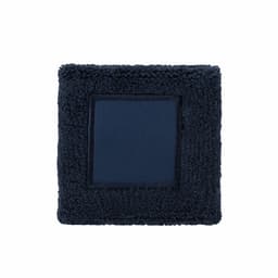 A square navy blue plush item with a smooth central panel, featuring a textured border.