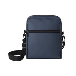 A navy blue crossbody bag with a zippered front pocket and an adjustable strap. The bag has a subtle logo.