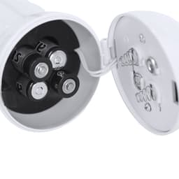 A battery compartment featuring four AA batteries inside a white casing, with visible wiring and contacts.